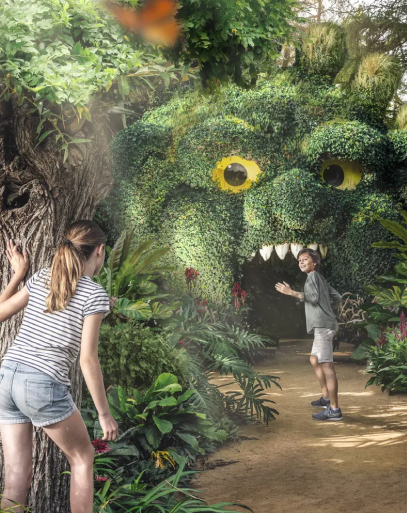 Photo de deux enfants jouant dans un parc avec des végétaux en forme de visage.